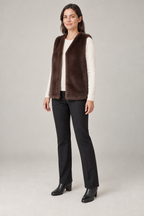 Three-quarter view of a cocoa faux fur vest design on a woman