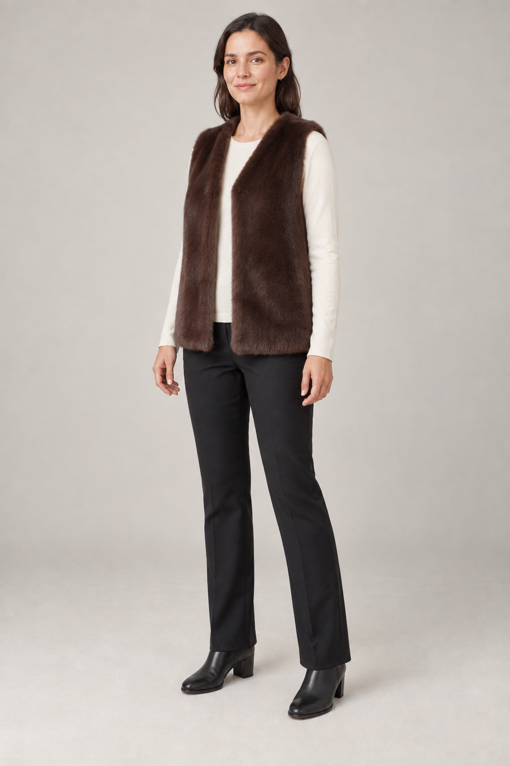 Three-quarter view of a cocoa faux fur vest design on a woman