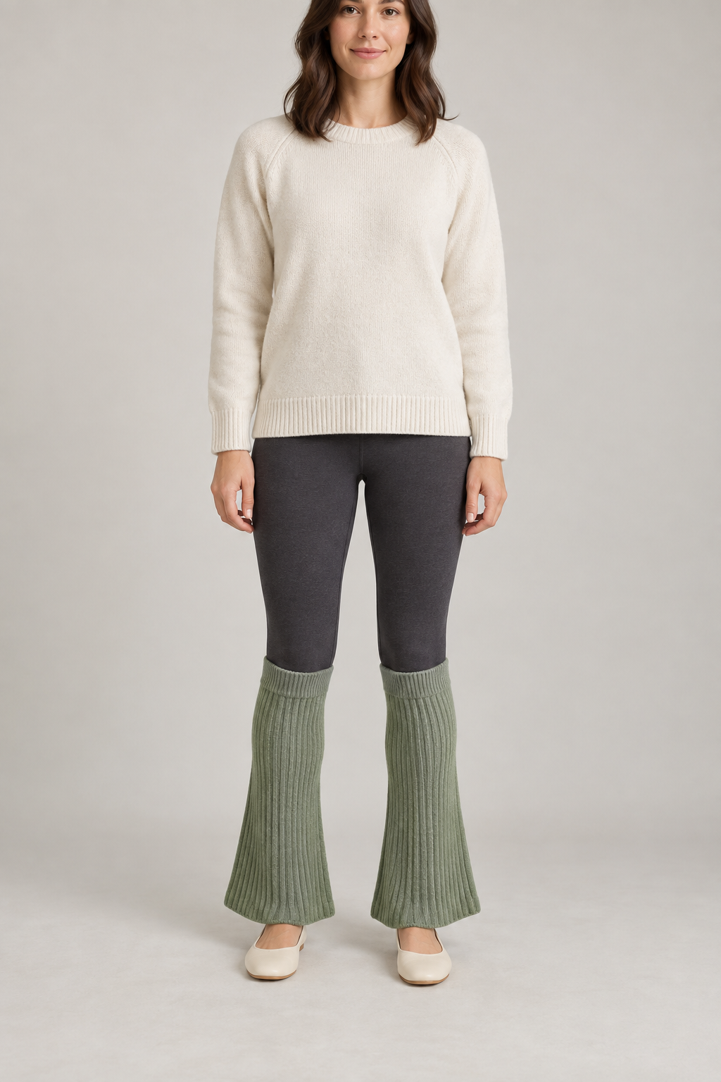Front design preview of sage flared leg warmers worn over dark leggings.