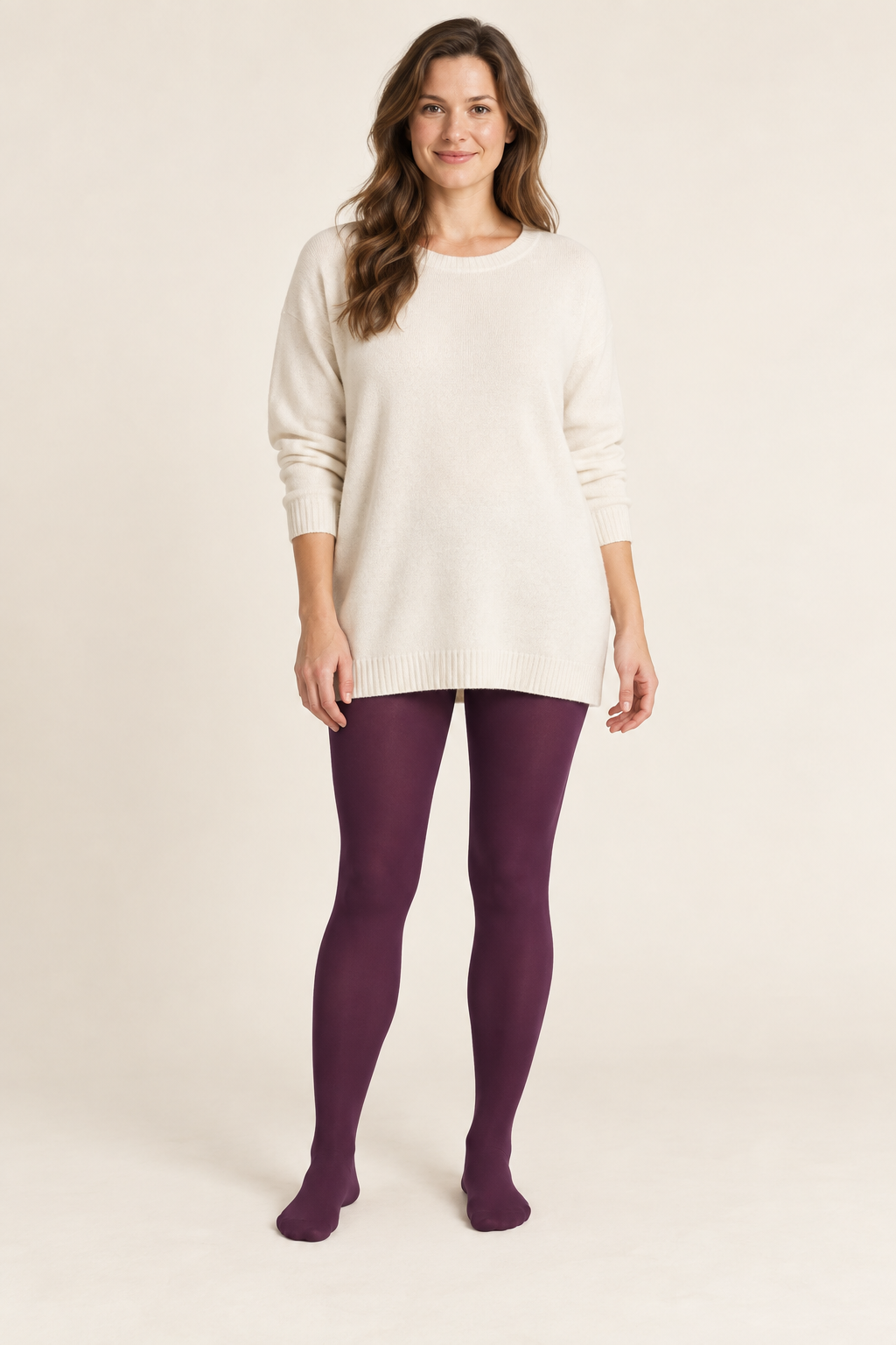Front design preview of plum footed tights styled with a cream tunic.