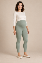 Three-quarter view of sage-green maternity leggings with a soft over-bump panel and ankle-length legs. Generated design preview.
