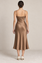 AI preview: bronze cowl-slip dress rear with straight shoulder straps, a shallow back edge, center-back seam and plain midi hem.