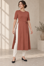 AI design preview: muted clay color of the same tie-waist knit tunic with long open side panels over ivory trousers
