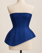 AI preview: rear of the sapphire strapless top with a concealed center-back zipper and matching asymmetric hem.