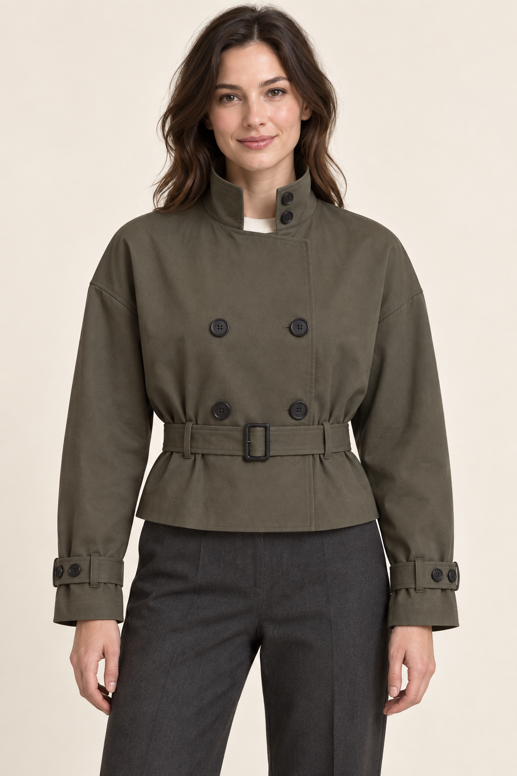 AI preview: olive-grey cropped trench jacket with a stand collar, double-breasted buttons, buckled belt and wrist straps.