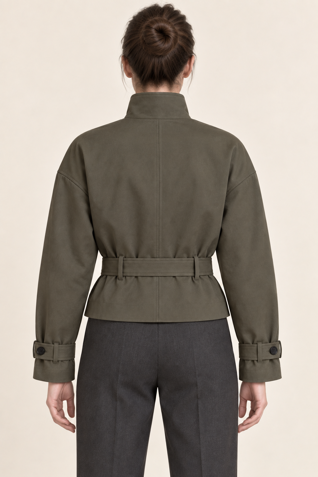 AI preview: back of the olive-grey cropped trench with a center seam, belt loops, dropped shoulders and plain upper-hip hem.