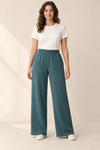 AI preview: deep-teal knit wide-leg pants with a high enclosed elastic waist, side-seam pockets and plain full-length hems.
