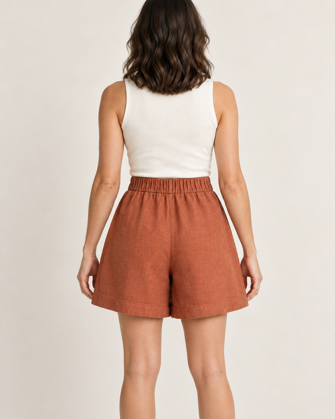 AI design preview: terracotta shorts back with gathered elastic waist, plain seat and deep stitched hems