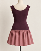 AI preview: scoop back and center-back seam of the plum knit bodice with the same short dusty-rose woven skirt.