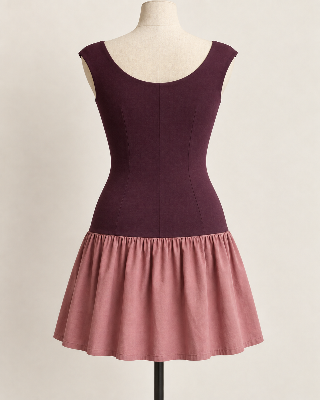 AI preview: scoop back and center-back seam of the plum knit bodice with the same short dusty-rose woven skirt.