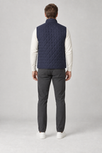 Back view of a men's navy diamond-quilted vest design