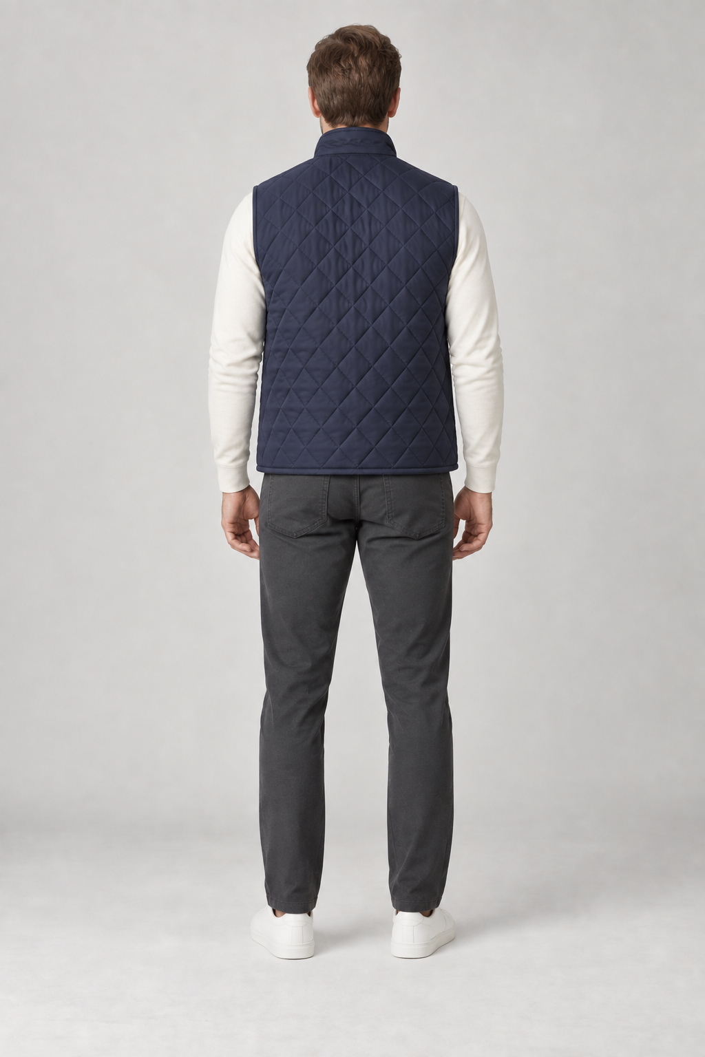 Back view of a men's navy diamond-quilted vest design