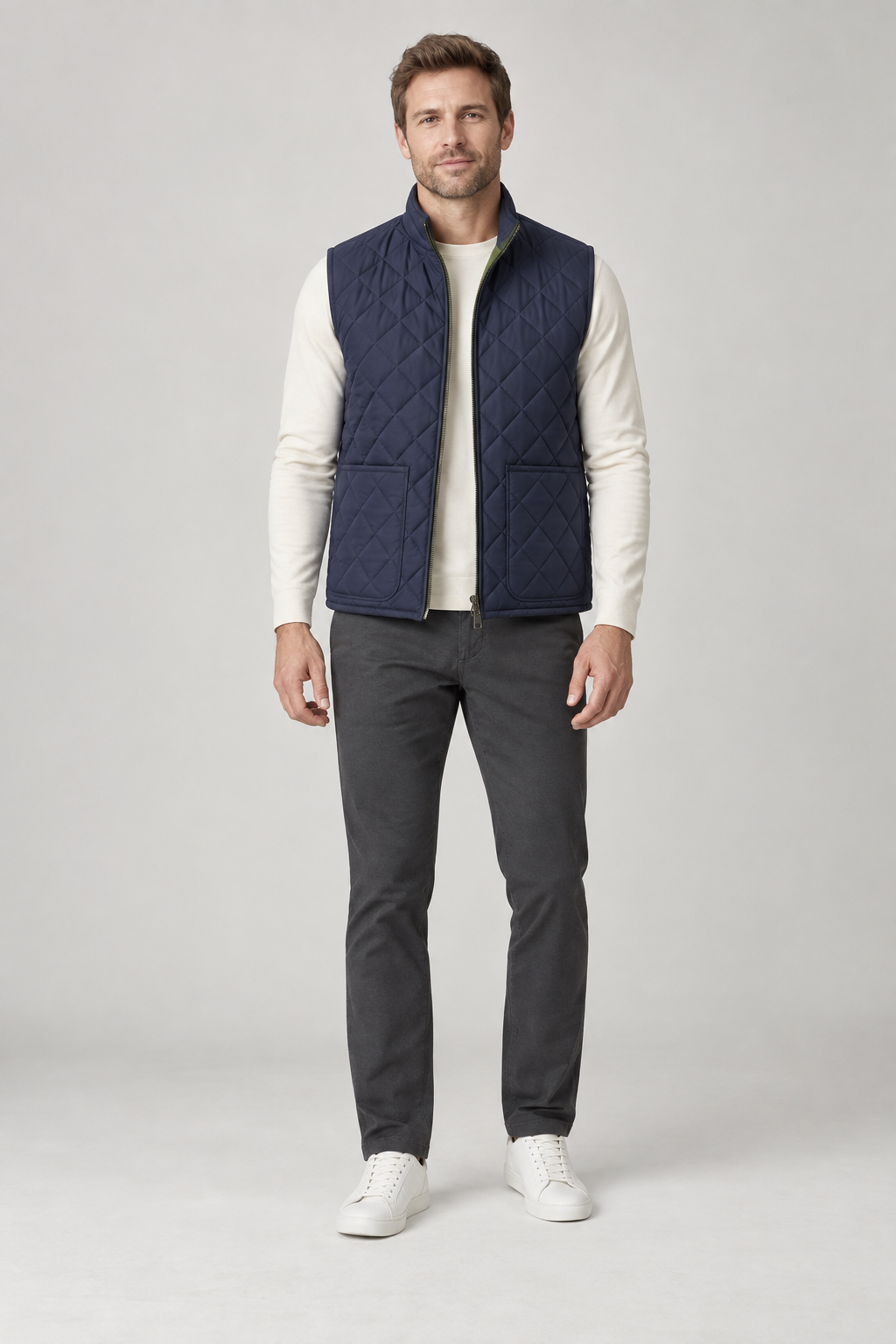 Front view of a men's navy diamond-quilted vest design with two patch pockets