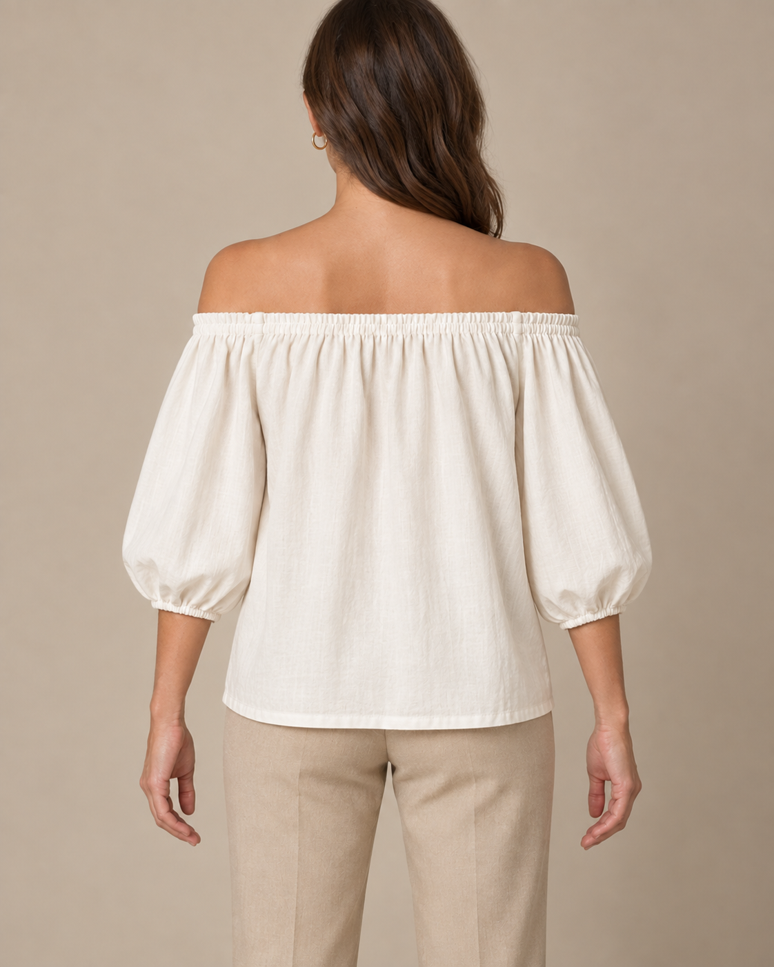 Ivory off-shoulder blouse design with gathered neckline and three-quarter sleeves, back view.