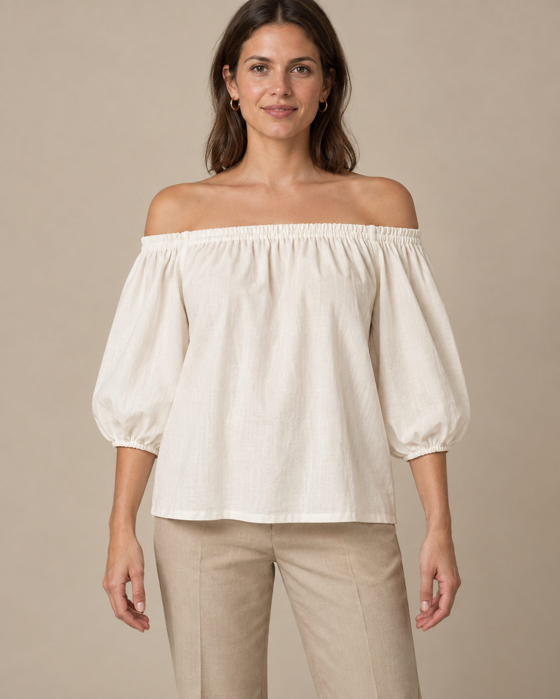 Ivory off-shoulder blouse design with gathered neckline and three-quarter sleeves, front view.