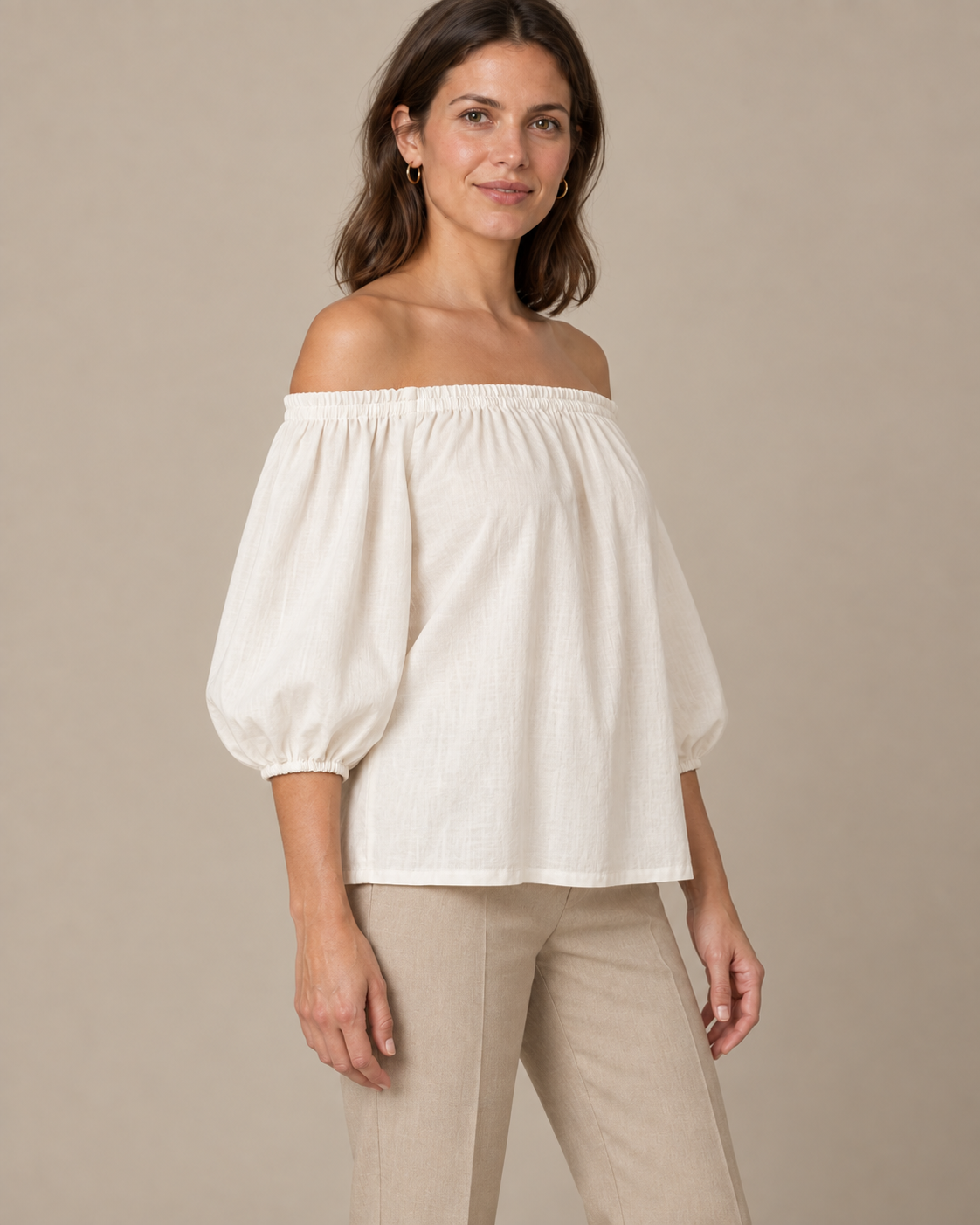 Ivory off-shoulder blouse design with gathered neckline and three-quarter sleeves, three-quarter view.