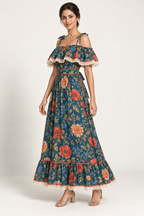 Three-quarter view of the SL001 floral maxi dress, showing the shoulder flounce, fitted waistband and hem ruffle. AI design concept.