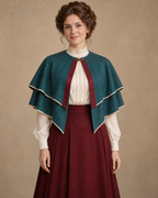 Front view of the teal double-tier bolero cape with burgundy front bands and pointed ends