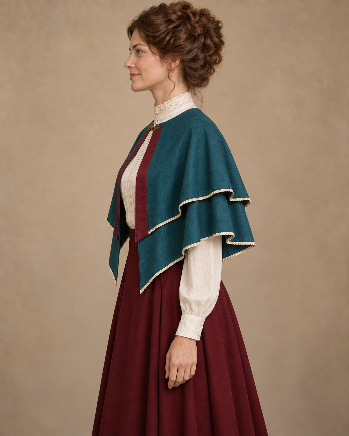 Side view of the peacock teal bolero cape with two curved ivory-trimmed hems