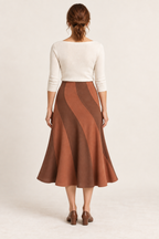 Terracotta and cinnamon spiral-panel midi skirt, back view on a woman; generated design preview.
