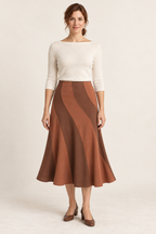 Terracotta and cinnamon spiral-panel midi skirt, front view on a woman; generated design preview.