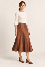 Terracotta and cinnamon spiral-panel midi skirt, three quarter view on a woman; generated design preview.