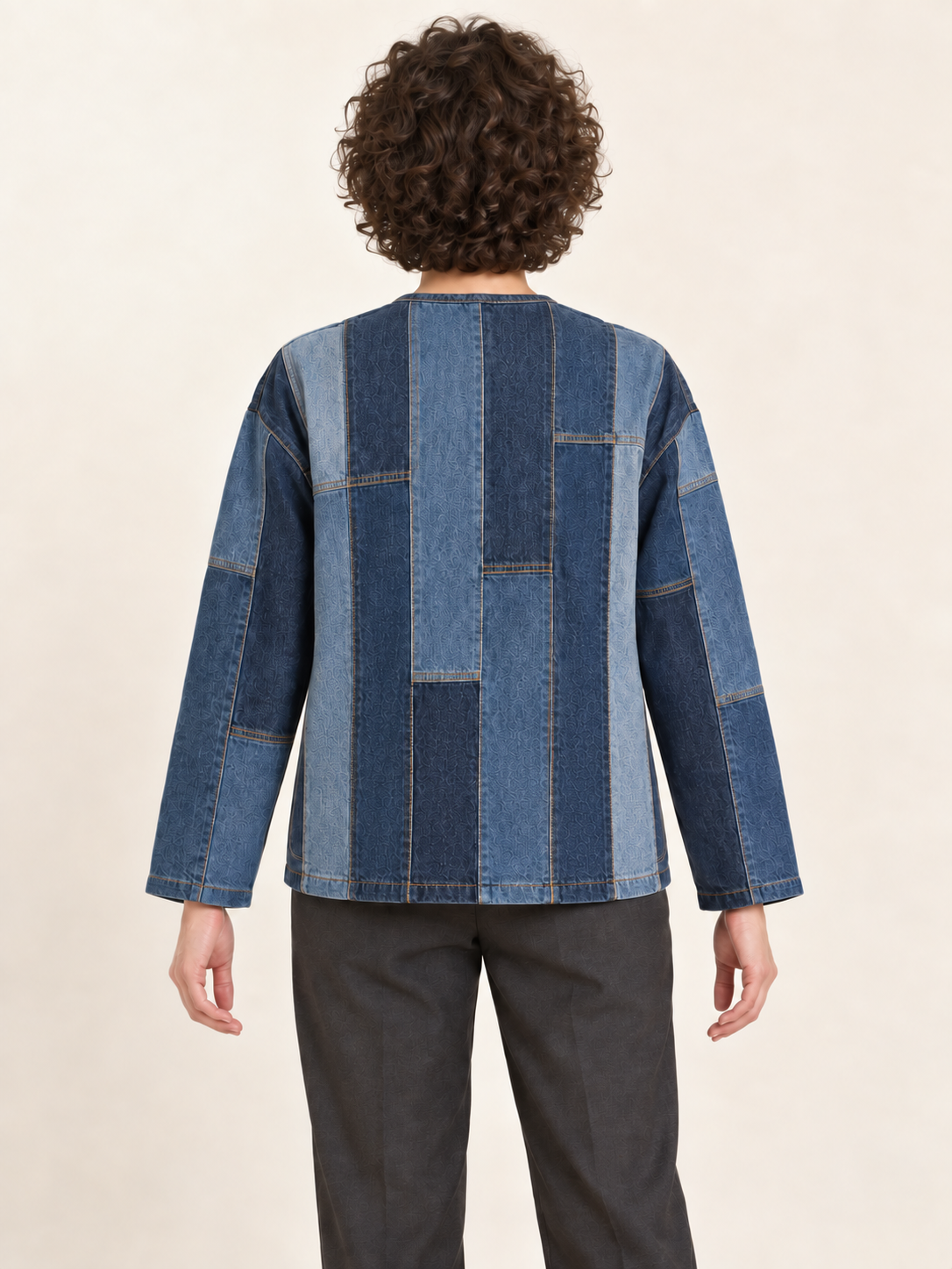 Back view of a collarless upcycled denim jacket showing the flat modular panel assembly; generated design preview.