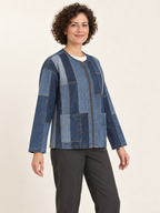 Three-quarter view of an upcycled denim panel jacket showing the zip front and lower patch pockets; generated design preview.