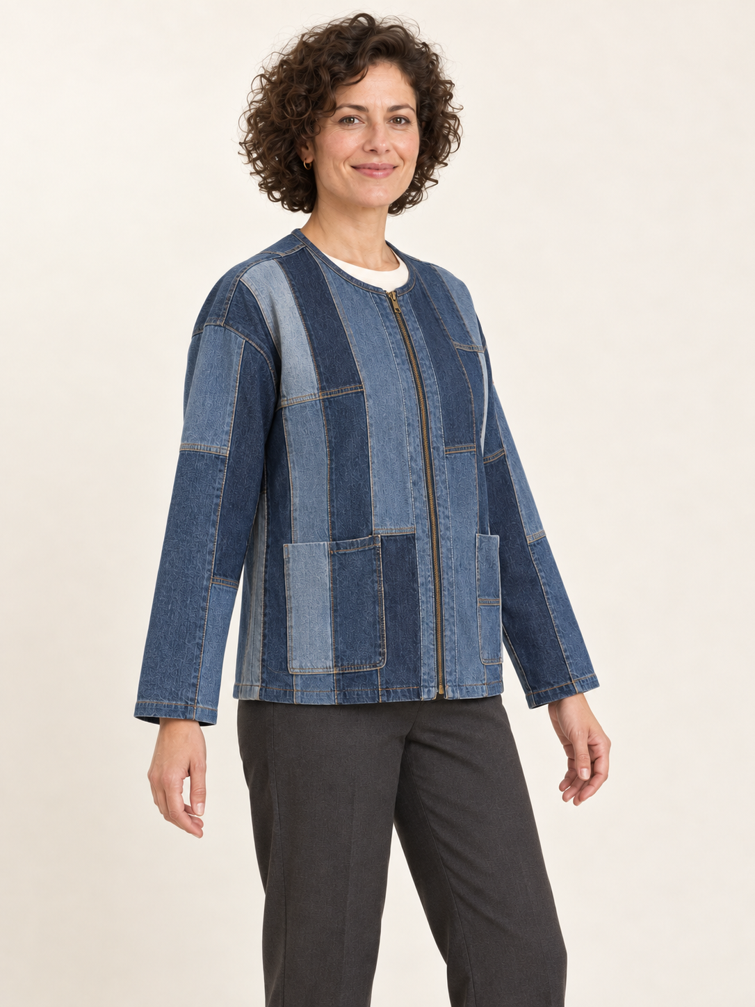 Three-quarter view of an upcycled denim panel jacket showing the zip front and lower patch pockets; generated design preview.