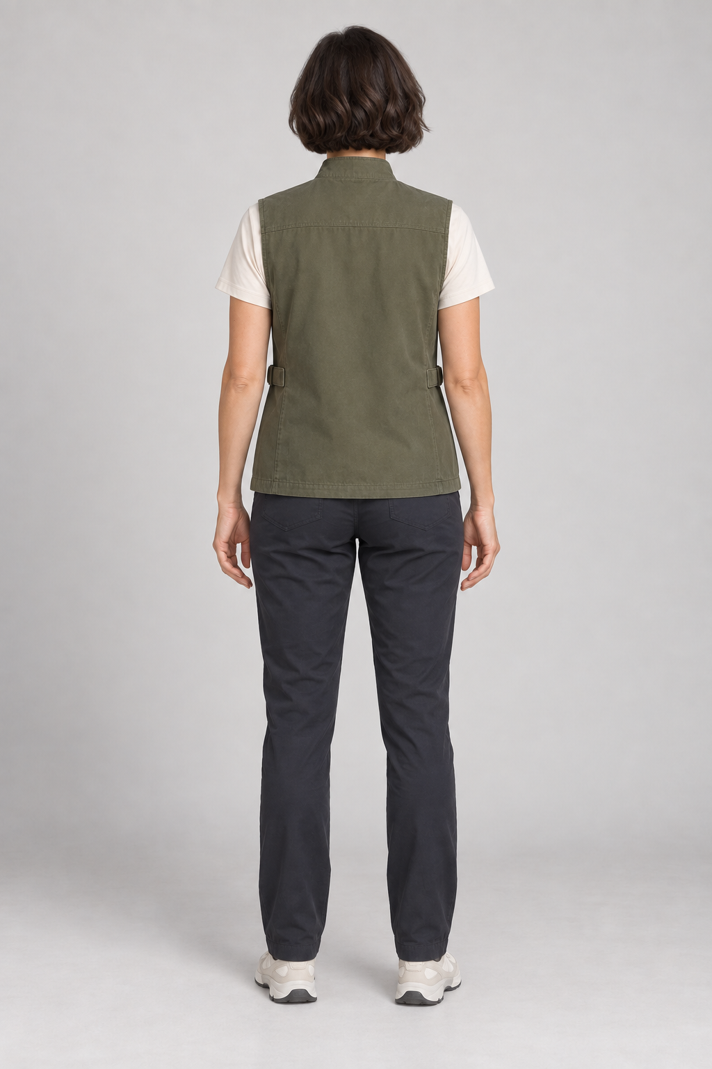Back view of an olive four-pocket utility vest design on a woman