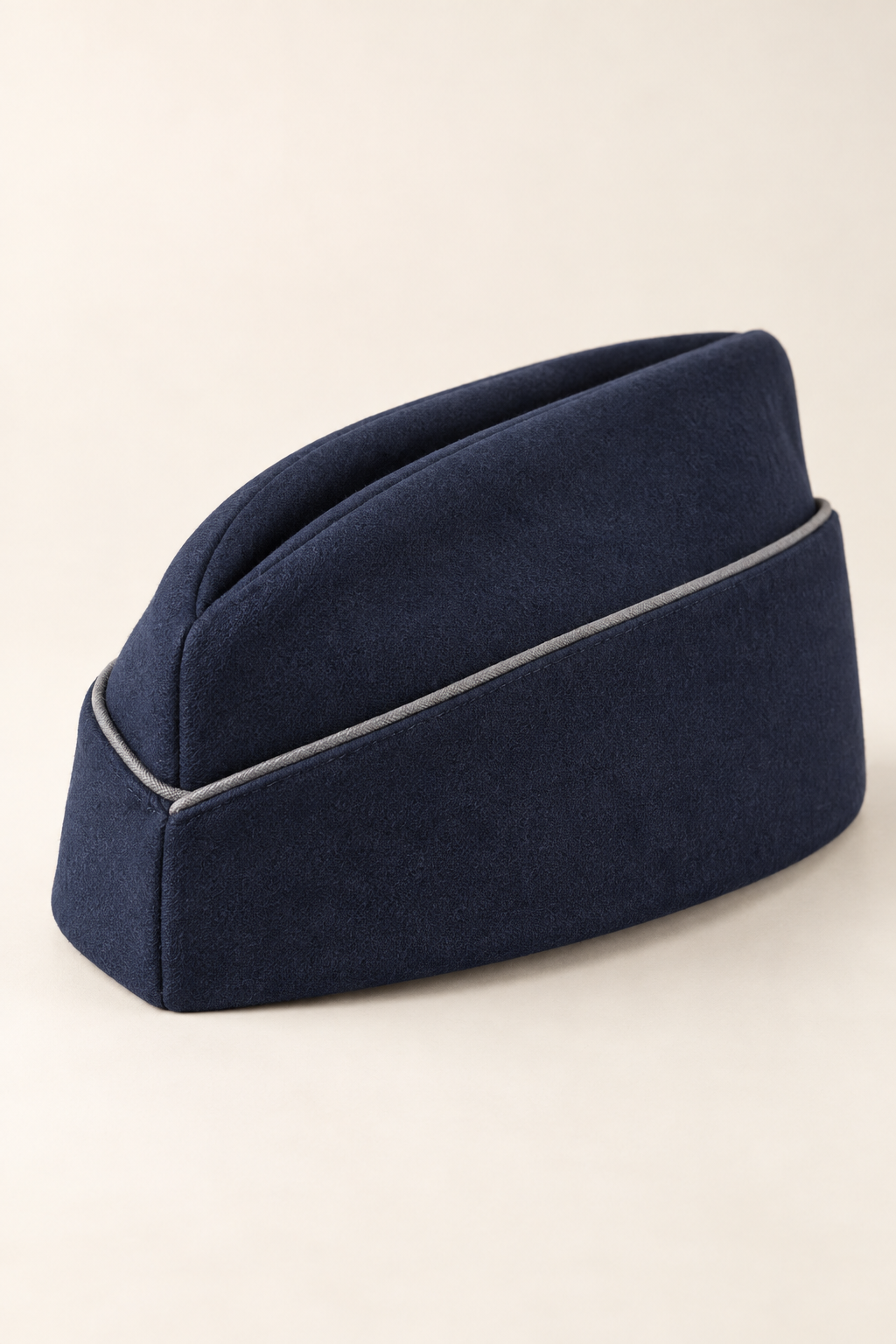 AI design preview: navy garrison cap with a folded wedge crown, turned-up band and narrow grey piping.