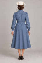 AI design preview: slate-blue nurse dress with gathered back yoke, cuffed sleeves and folded cap, rear.