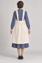 AI design preview: ivory pinafore rear with parallel straps, buttoned waistband and skirt overlap.