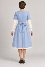 AI design preview: powder-blue canteen apron with full back, button opening and waist ties, rear.