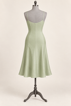 AI back preview of the pistachio slip with a shallow neckline and shaped panels flowing into a flared skirt