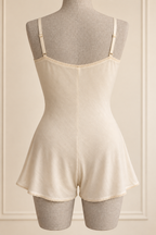 AI preview: ivory teddy rear with adjustable straps, shallow curved back edge and divided legs.