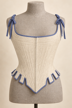 AI preview: the same tabbed stays in antique ivory with slate-blue binding and shoulder ties.