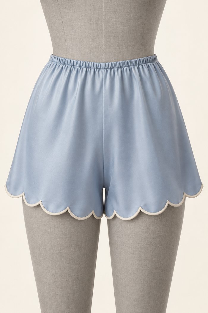 AI front preview of powder-blue bias-cut tap pants with an elastic waist and ivory-bound scalloped hems