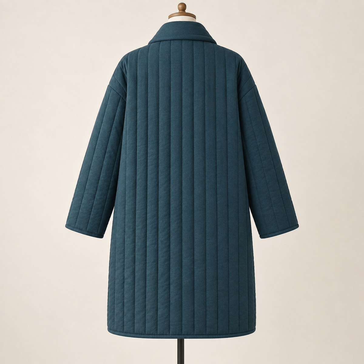 AI design preview: deep teal long quilted coat back with plain vertical channels, dropped shoulders and softly rolled rear collar