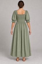 AI design preview: rear of the same sage maxi dress, showing a square back neckline, fully shirred back bodice and one gathered ankle-length skirt