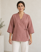 AI design preview: adult woman in a mineral-rose side-tie lounge jacket with a flat V-front band and one patch pocket