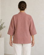 AI design preview: rear of the same rose lounge jacket, showing center-back seam, dropped shoulders and wide sleeves