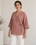 AI design preview: three-quarter view of the same woman and rose wrap jacket, showing side bow, flat band and patch pocket