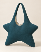 AI design preview: plain rear of the same teal star hobo showing the narrow perimeter gusset and ivory lining edge