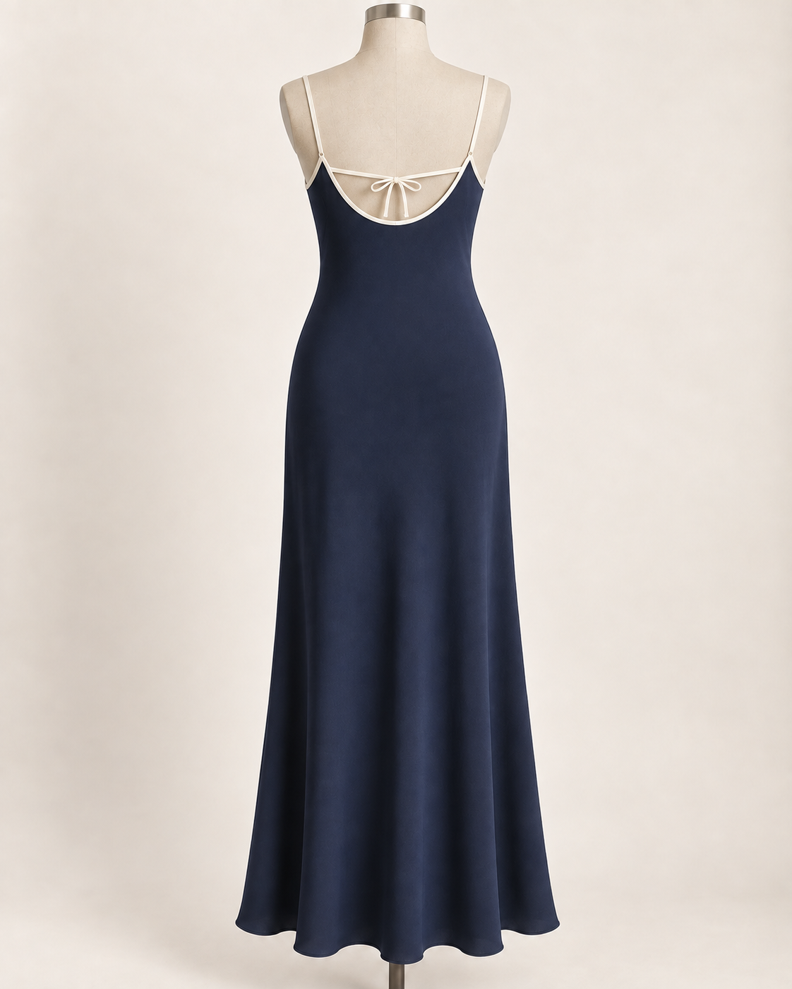 AI preview: ink-blue slip dress rear with a low U-shaped bound edge and a fine tie across the upper back.