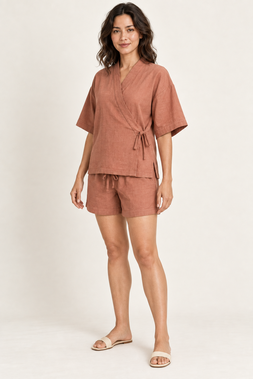AI design preview: same terracotta Jinbei-inspired top and shorts in three-quarter view, showing flat neckband, compact side tie and plain hems