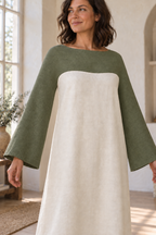 Close view of continuous sage yoke sleeves and smooth ivory body below the curved chest seam